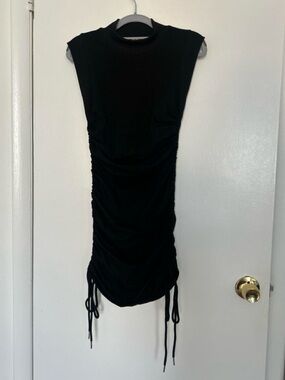 Salty black mini dress with side ruching and tie detail. Size M